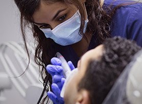 Assistant treating dental patient